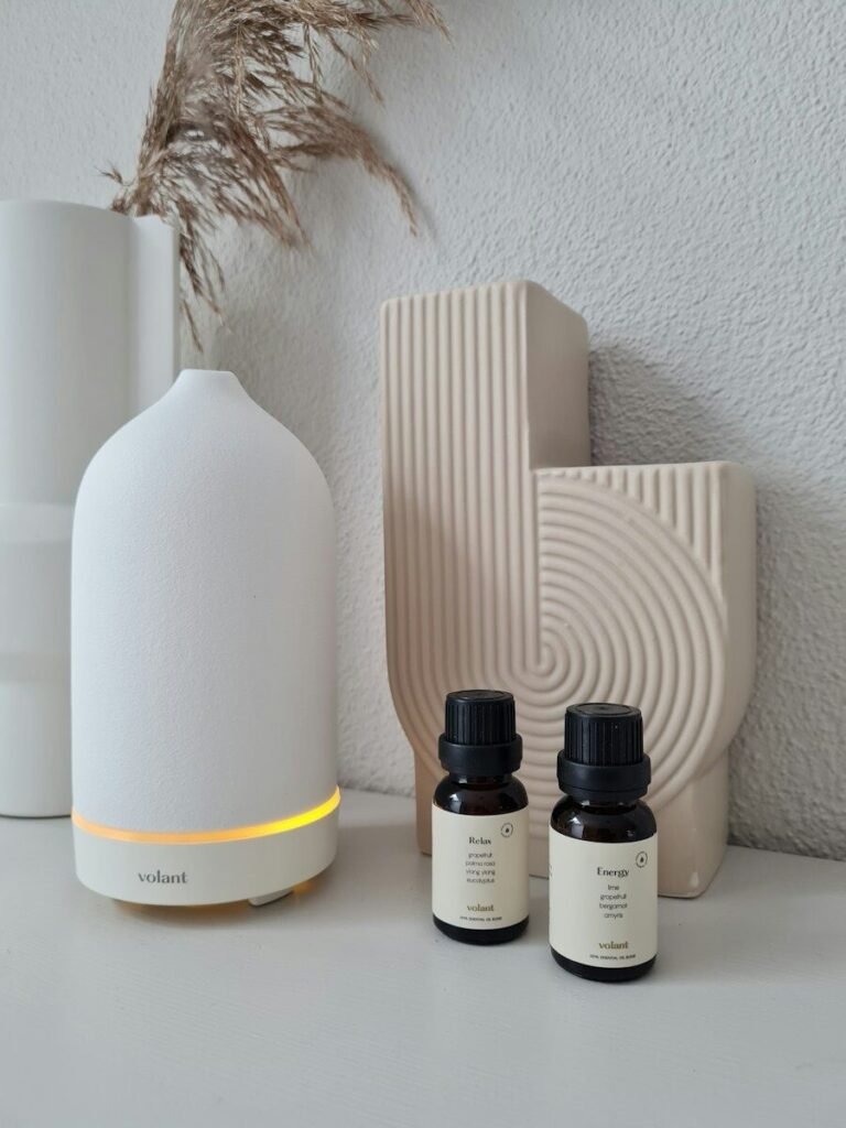 three bottles of essential oils sitting on a table